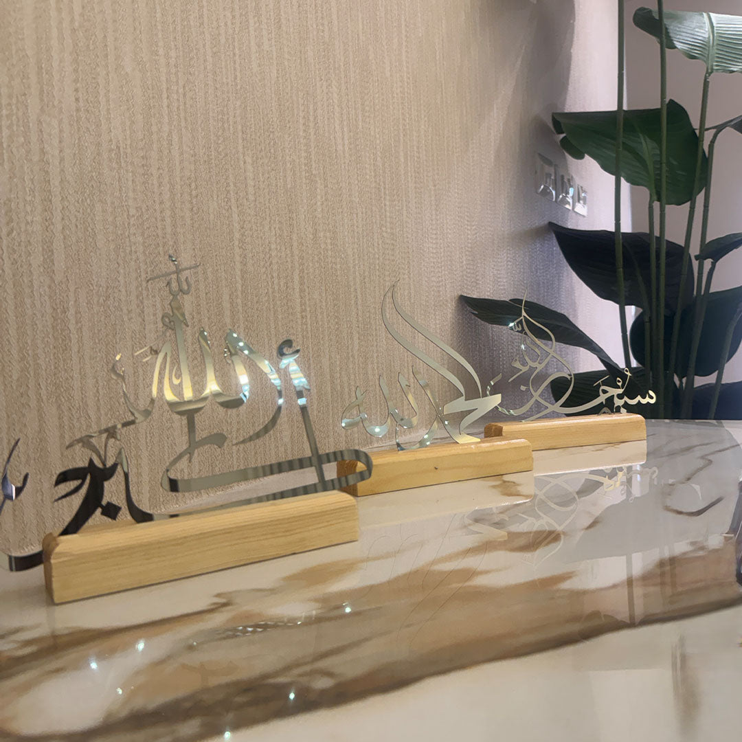 Decorative item with wooden base and glass panels on a reflective surface.